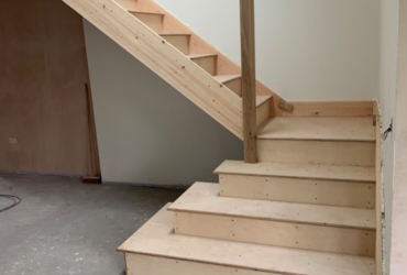 carpeted stairs & oak balustrade before